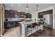 Modern kitchen featuring dark cabinets, stainless appliances, and island with bar seating at 1893 Glenmoor Ct, Columbus, IN 47201