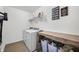 Efficient laundry room with modern appliances, folding table, and organized storage baskets at 1893 Glenmoor Ct, Columbus, IN 47201