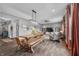 Open-concept living room featuring hardwood floors, a cozy seating area, and modern lighting, seamlessly flows into the breakfast nook at 1893 Glenmoor Ct, Columbus, IN 47201