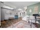 Inviting living room featuring skylights, stylish decor, wood floors, and staircase at 1893 Glenmoor Ct, Columbus, IN 47201