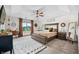 Serene main bedroom featuring a tray ceiling, a ceiling fan, a sitting area, and a view at 1893 Glenmoor Ct, Columbus, IN 47201
