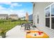 Cozy patio with outdoor dining set, umbrella, grill, and sandbox; perfect for entertaining at 1893 Glenmoor Ct, Columbus, IN 47201
