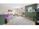 Spacious playroom with carpet, lots of toys, natural light, and cozy decor for children at 1893 Glenmoor Ct, Columbus, IN 47201