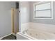 Shower and tub combo featuring a glass door and tiled walls at 2 E Quail Wood Ln, Westfield, IN 46074