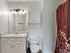 Bright bathroom features vanity with storage, a mirror, and a toilet at 2 E Quail Wood Ln, Westfield, IN 46074