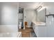 Bathroom featuring double sinks, soaking tub, and wood-look flooring at 2 E Quail Wood Ln, Westfield, IN 46074
