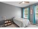 Well lit bedroom featuring neutral walls, and a single window with blue curtains at 2 E Quail Wood Ln, Westfield, IN 46074