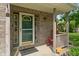 Charming front porch featuring brick accents, a storm door, and a cozy rocking chair at 2 E Quail Wood Ln, Westfield, IN 46074