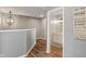 Second-floor hallway with a view of a bathroom and decorative Gathering rules hanging from the wall at 2 E Quail Wood Ln, Westfield, IN 46074