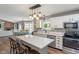 Modern kitchen with an island, pendant lighting, stainless steel appliances, white cabinets, and a view of the dining area at 2 E Quail Wood Ln, Westfield, IN 46074