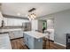 Bright kitchen with white cabinets, stainless steel appliances, an island, and lots of counterspace at 2 E Quail Wood Ln, Westfield, IN 46074