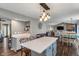 Open-concept kitchen flowing into the living room, complete with island, modern lighting and stainless appliances at 2 E Quail Wood Ln, Westfield, IN 46074