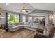 Spacious living room with a brick fireplace, hardwood flooring, and a comfortable sofa with ample natural light at 2 E Quail Wood Ln, Westfield, IN 46074