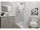 Bright bathroom with a glass enclosed shower, rain shower head, and stylish vanity with gold fixtures at 2009 Friendship Dr, Indianapolis, IN 46217