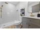 Bright bathroom featuring a stylish vanity with gold hardware, a modern shower with rainfall showerhead, and tile surround at 2009 Friendship Dr, Indianapolis, IN 46217