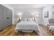 Inviting bedroom features wood floors, a plush white bed with throw pillows, and stylish bedside lamps at 2009 Friendship Dr, Indianapolis, IN 46217