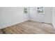 Simple bedroom featuring a window and wood-look flooring and fresh white walls at 2009 Friendship Dr, Indianapolis, IN 46217
