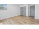 Simple bedroom with wood floors, a window for natural light, and a closet with dark gray doors at 2009 Friendship Dr, Indianapolis, IN 46217