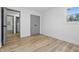 Bright room featuring a window, wood-look flooring, fresh white walls, and a door at 2009 Friendship Dr, Indianapolis, IN 46217