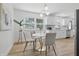 Cozy dining area with a modern table, chairs, and bright natural lighting from the window at 2009 Friendship Dr, Indianapolis, IN 46217