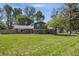 Charming brick and siding two-story home with a spacious front yard and mature trees at 2009 Friendship Dr, Indianapolis, IN 46217