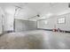 This large vacant garage includes room for multiple cars, storage, and lots of natural light at 2009 Friendship Dr, Indianapolis, IN 46217