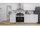 Stylish kitchen featuring stainless steel oven, white cabinets, and a decorative backsplash at 2009 Friendship Dr, Indianapolis, IN 46217
