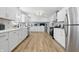 Modern kitchen with white cabinets, stainless steel appliances, and light wood floors at 2009 Friendship Dr, Indianapolis, IN 46217