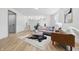 Bright living room features wood floors, a modern sofa and an area rug with a cowhide pattern at 2009 Friendship Dr, Indianapolis, IN 46217