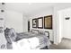 Bright bedroom featuring an industrial-style bed frame, neutral decor, and three decorative wall mirrors at 2243 Hemlock Cir, Greenfield, IN 46140