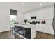 Modern kitchen with white cabinets, a contrasting island, stainless steel appliances, and luxury vinyl plank flooring at 2243 Hemlock Cir, Greenfield, IN 46140