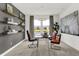 Well-lit home office featuring a modern desk, comfortable chairs, open shelving and large window at 2243 Hemlock Cir, Greenfield, IN 46140