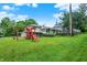Expansive yard with a playset visible from the rear of the house at 313 E South St, Morristown, IN 46161