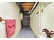 Hallway with pink towels, storage shelf and basement access at 313 E South St, Morristown, IN 46161