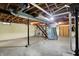 Bright unfinished basement with exposed ceiling beams, concrete floor, and modern utilities at 313 E South St, Morristown, IN 46161
