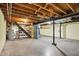 Spacious unfinished basement features wood beams, support pillars and concrete flooring at 313 E South St, Morristown, IN 46161