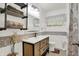 Bathroom features a modern vanity, decorative lighting and tiled walls at 313 E South St, Morristown, IN 46161