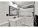 Updated bathroom with tiled walk-in shower, modern vanity and decorative mirror at 313 E South St, Morristown, IN 46161
