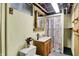 Cozy bathroom with decorative shower curtain, wood vanity, and tiled floor at 313 E South St, Morristown, IN 46161
