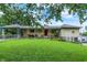Charming ranch home with inviting front porch, lush lawn, and convenient carport at 313 E South St, Morristown, IN 46161
