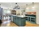 Charming kitchen boasts a marble island, custom cabinets, and views into the dining and living spaces at 313 E South St, Morristown, IN 46161
