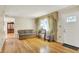 Bright living room with hardwood floors, large window, and comfortable seating at 313 E South St, Morristown, IN 46161