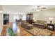 Warm living room showcasing hardwood floors, an open layout to the kitchen and dining area at 313 E South St, Morristown, IN 46161