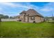 Home exterior shows manicured lawn, mature trees and a neutral exterior at 3247 Moonlight Ct, Columbus, IN 47203