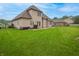 Large manicured lawn in the backyard leads to the home's patio at 3247 Moonlight Ct, Columbus, IN 47203