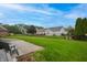 Beautifully maintained backyard featuring green grass and mature trees at 3247 Moonlight Ct, Columbus, IN 47203