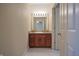 Bathroom vanity with warm wood cabinets, granite countertop, and well-lit mirror at 3247 Moonlight Ct, Columbus, IN 47203