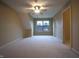 Large, empty room with carpet and a window, ideal for furnishing at 3247 Moonlight Ct, Columbus, IN 47203