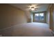 Unfurnished room with neutral walls, carpet flooring, and a window overlooking the neighborhood at 3247 Moonlight Ct, Columbus, IN 47203