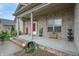 Inviting front porch featuring a brick facade, elegant columns, tasteful decor, and a welcoming entrance at 3247 Moonlight Ct, Columbus, IN 47203
